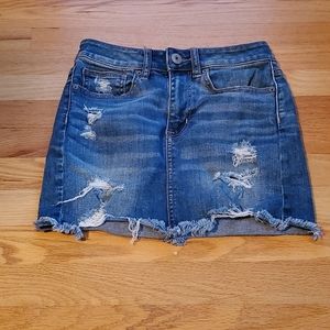 Distressed denim mini skirt